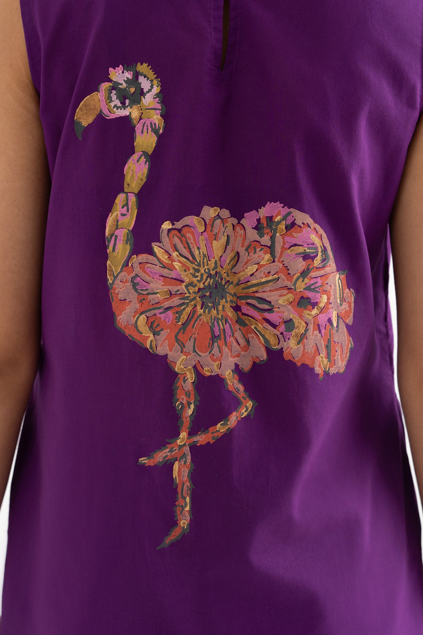 Close up on the block print flamingo on the purple dress.